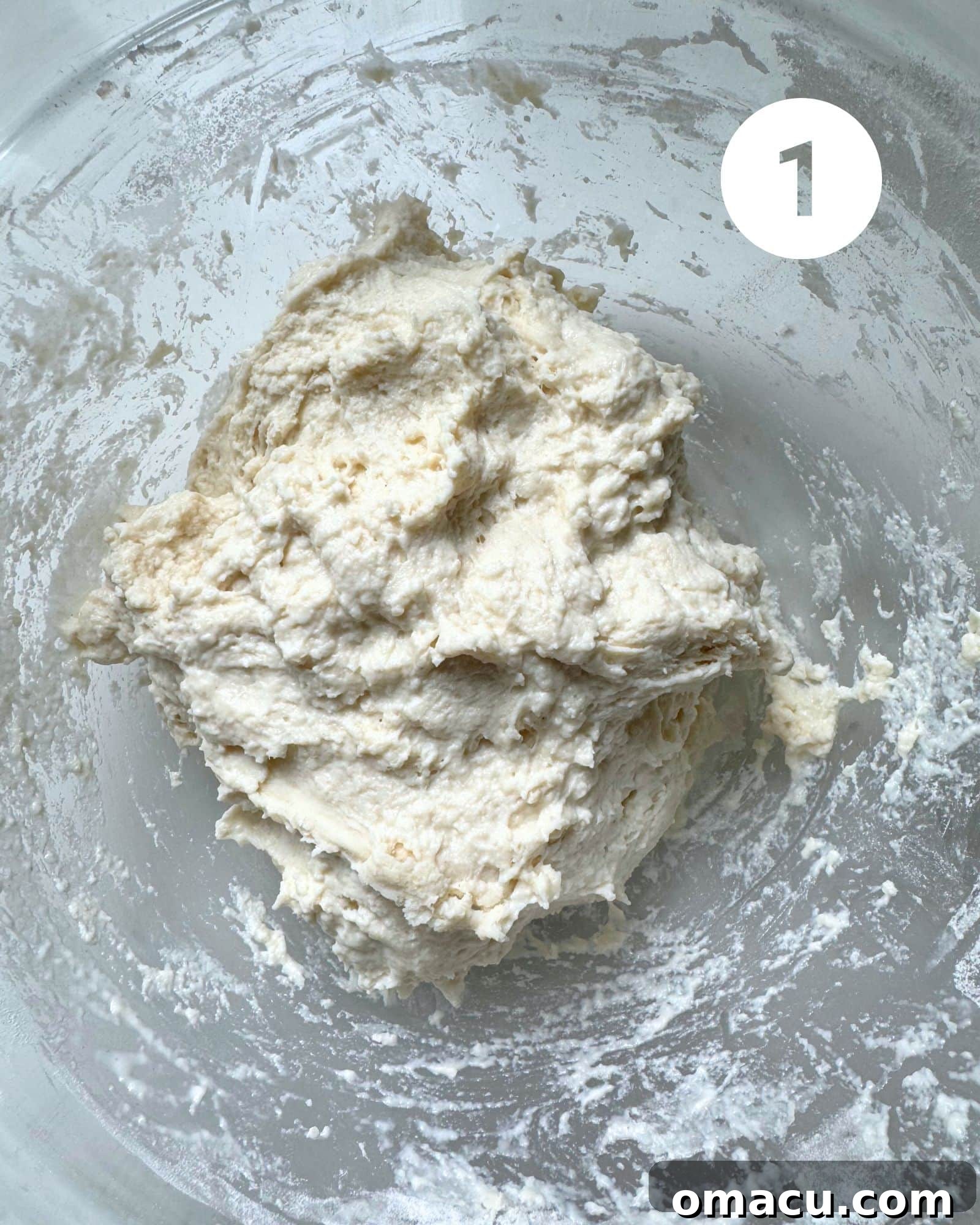 Olive bread dough in a mixing bowl after the first rest, before adding in the olives and fresh herbs.