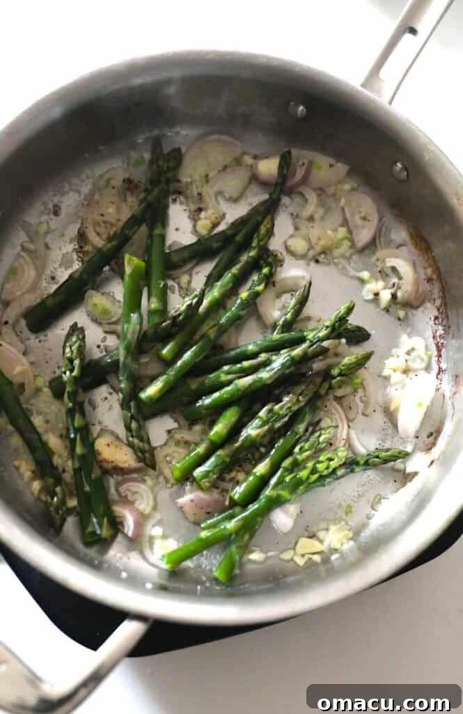 Asparagus, shallots, and garlic in a pan