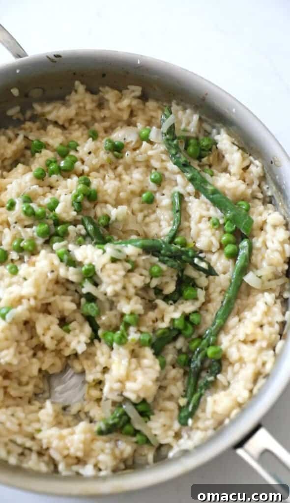 Risotto in a pan with peas and asparagus