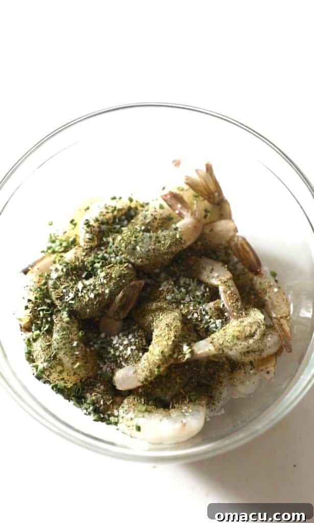 Shrimp in a bowl with seasonings on top