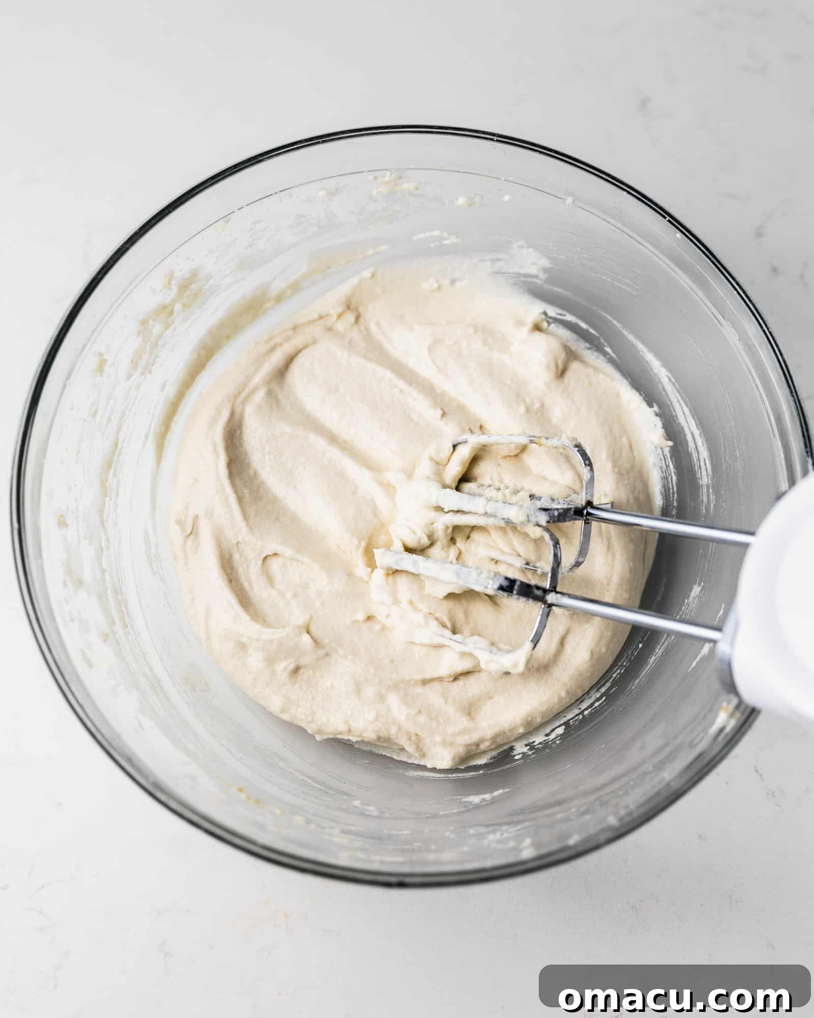 Creamed butter and sugar mixture in a large mixing bowl, showing the light and fluffy texture, ready for the next ingredients.