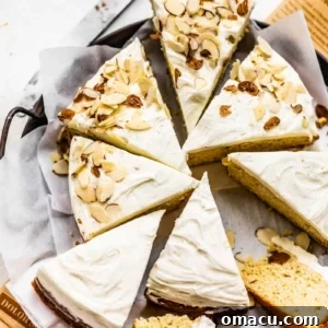 An almond cake cut into slices on parchment paper