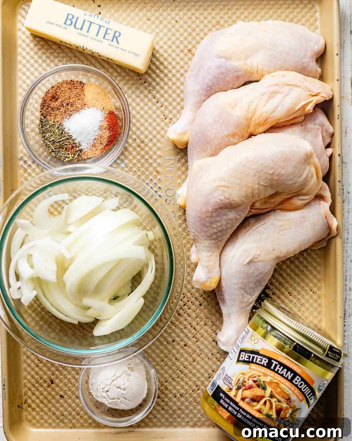 All the essential ingredients for baked chicken leg quarters neatly arranged on a baking tray.