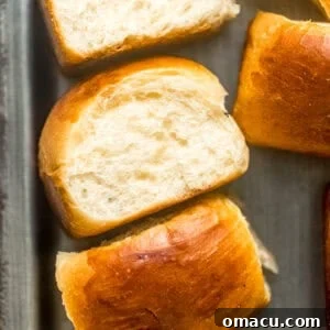 Golden-brown homemade Hawaiian rolls on a serving plate, ready to be enjoyed.