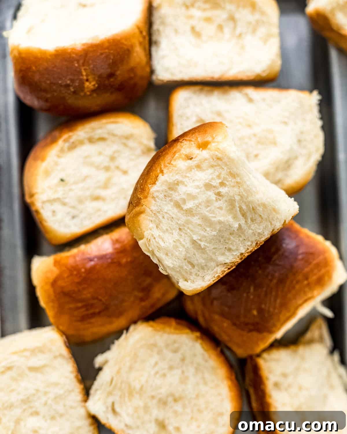 A serving tray filled with freshly baked homemade Hawaiian rolls, ready to be enjoyed.