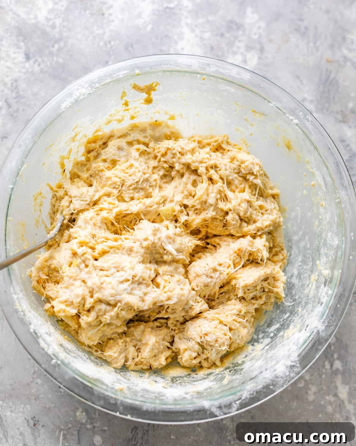 The fully mixed crab beignet batter in a bowl, showing its thick yet scoopable consistency.
