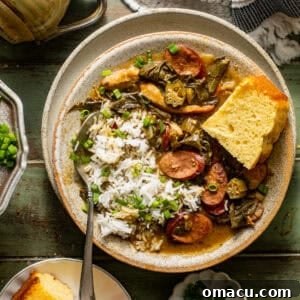 overhead photo of gumbo greens in a bowl with cornbread and rice garnished with chopped green onions.