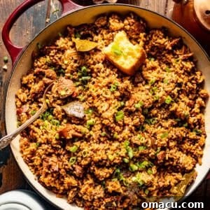 overhead photo of dirty rice in a pot with a piece of cornbread.