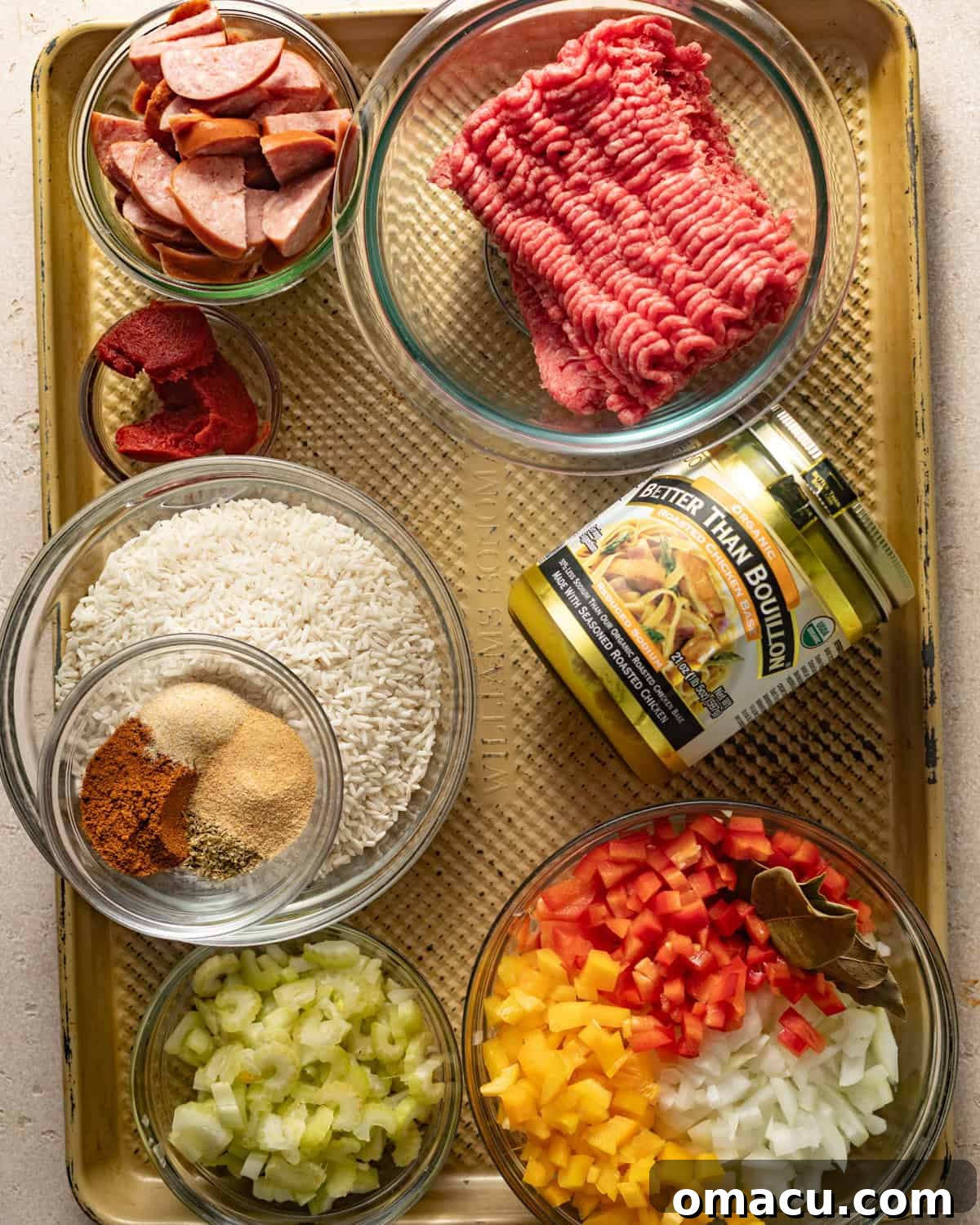 ingredients to make dirty rice - ground beef, andouille sausage, rice, bell pepper, onion, celery, chicken bouillon, seasonings, chicken broth, and worcestershire sauce. 