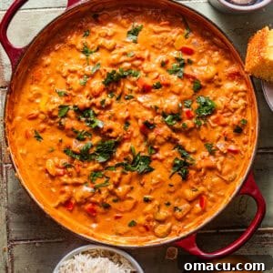 A close-up of crawfish étouffée in a pot, garnished with fresh parsley, highlighting the rich texture and vibrant colors of the dish.