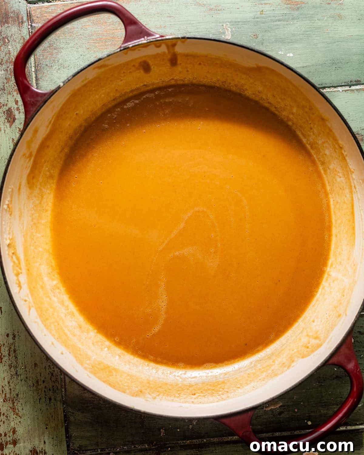 A light golden blonde roux being whisked in a large skillet, demonstrating the perfect color and consistency before adding vegetables.