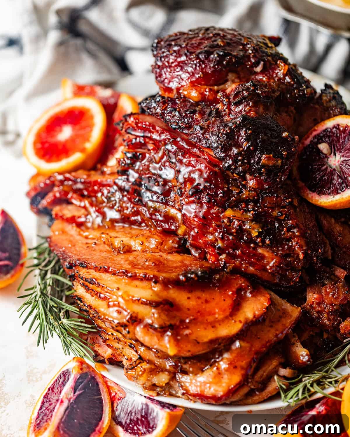 A generous slice of brown sugar mustard glazed ham, showing its juicy interior and caramelized crust, served on a plate ready to be enjoyed.