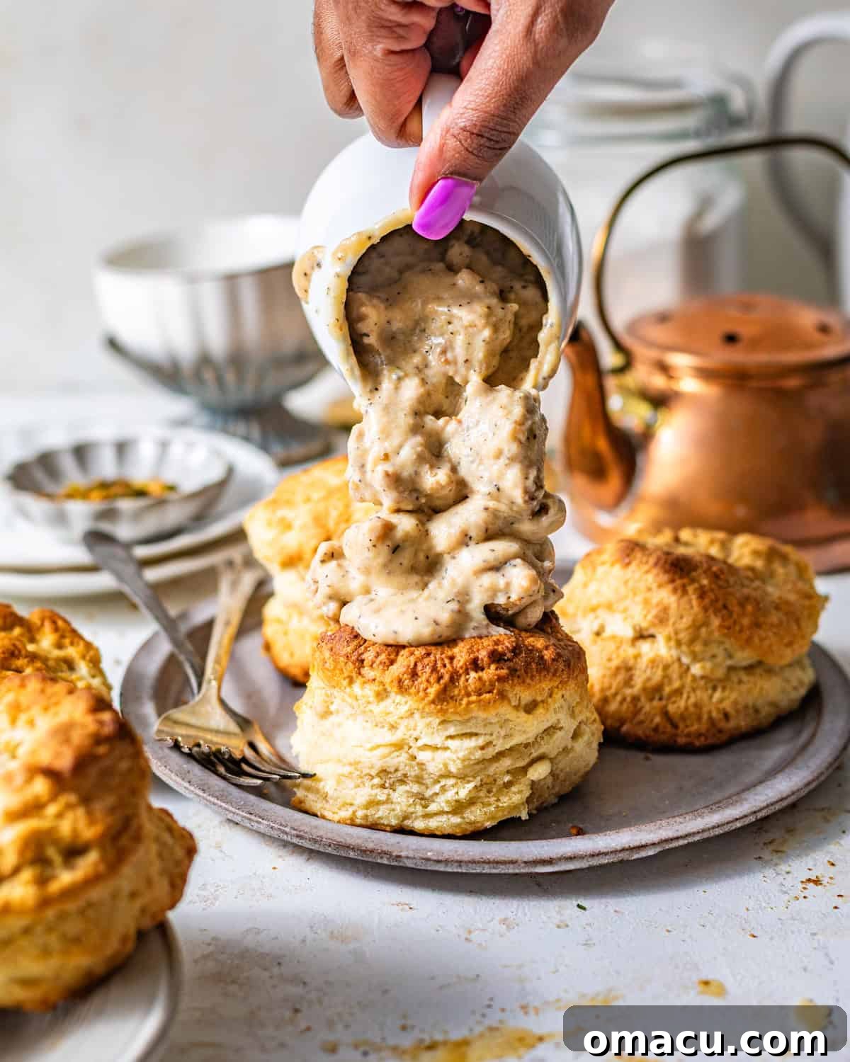 Gravy being poured over the biscuits.