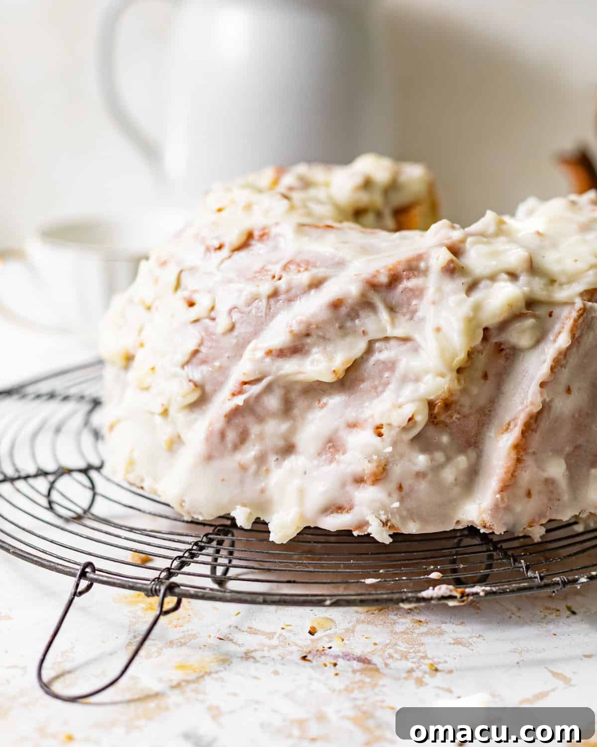 A freshly baked coconut pound cake cooling gracefully on a wire rack, its golden crust hinting at the deliciousness within.
