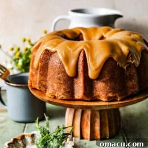Peanut butter pound cake on a cake stand topped with peanut butter fudge frosting.