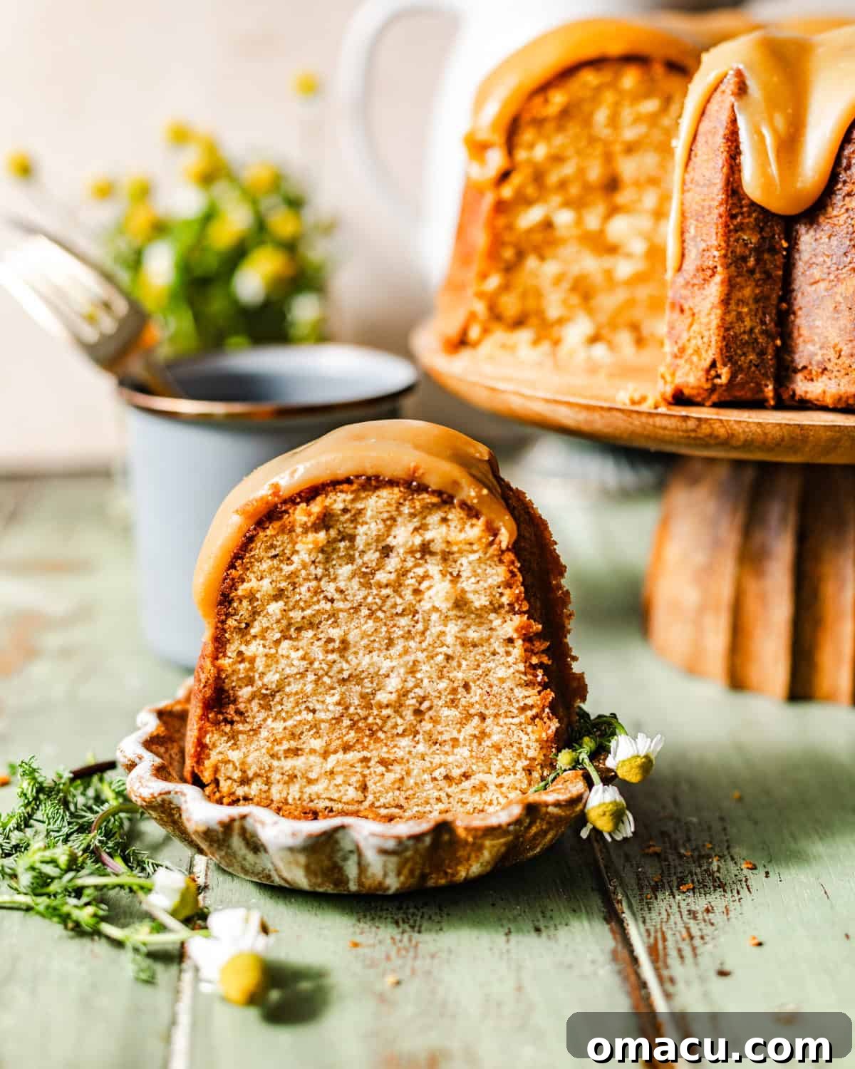 A perfectly sliced piece of peanut butter pound cake resting on a small, elegant plate, revealing its moist and tender crumb.