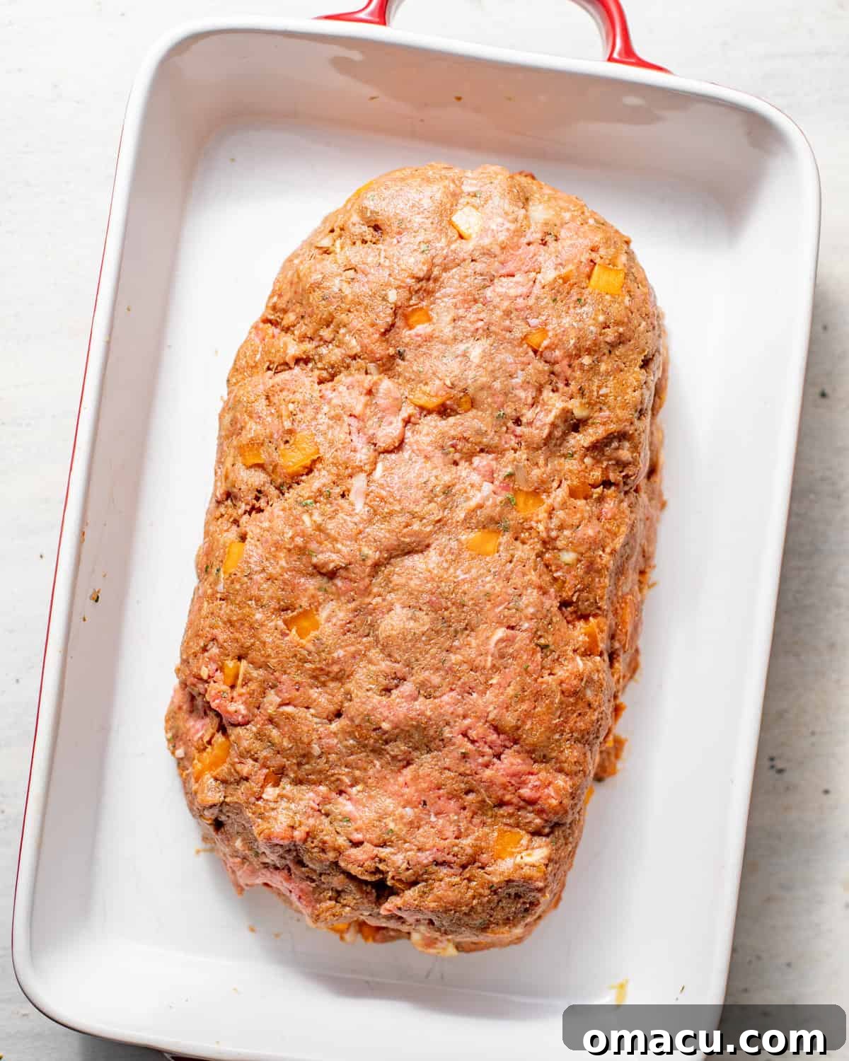 ground beef mixture shaped into a loaf in baking dish.