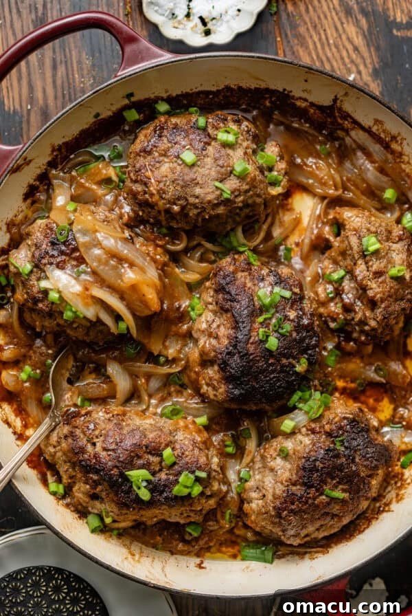 overhead photo of hamburger steaks in a skillet.