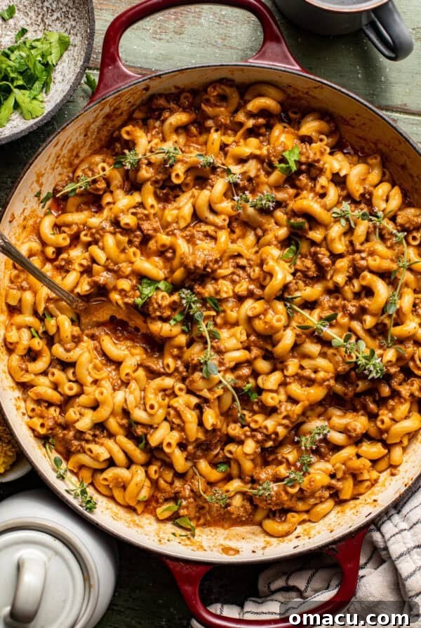 homemade hamburger helper in a pot with a spoon.