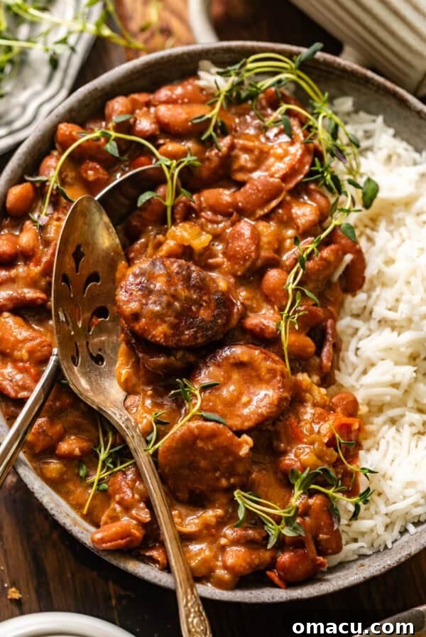 overhead photo of cajun red beans and rice in a bowl with a spoon.