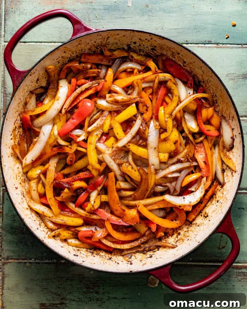 sauteed peppers and onions in a skillet.