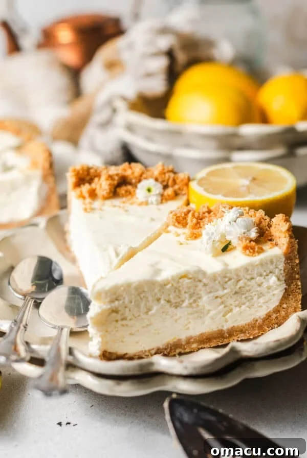 sliced lemon icebox pie on a plate with lemons and spoons.