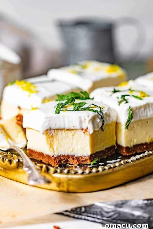 an up close photo of key lime pie bars on a plate with spoons.