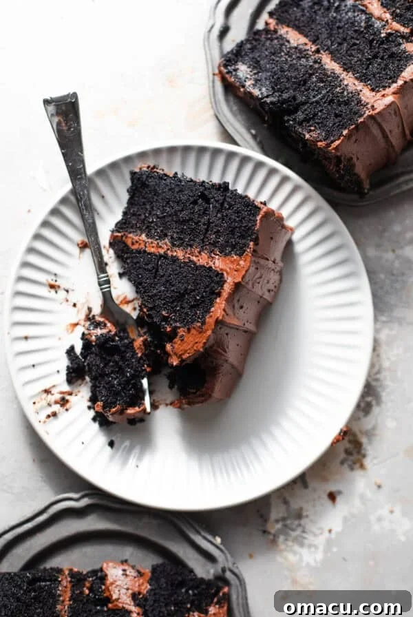 sliced chocolate cake on small plates with forks.