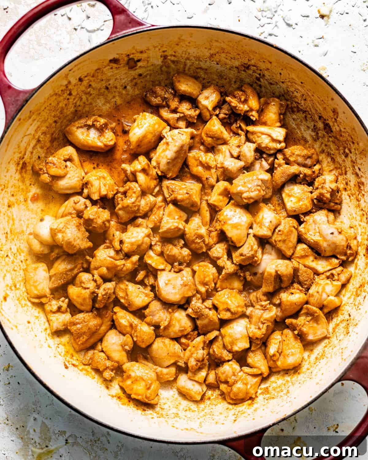 seared seasoned chicken in a skillet.