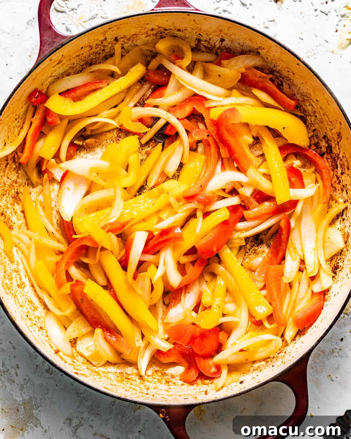 sauteed bell peppers and onions in a skillet.