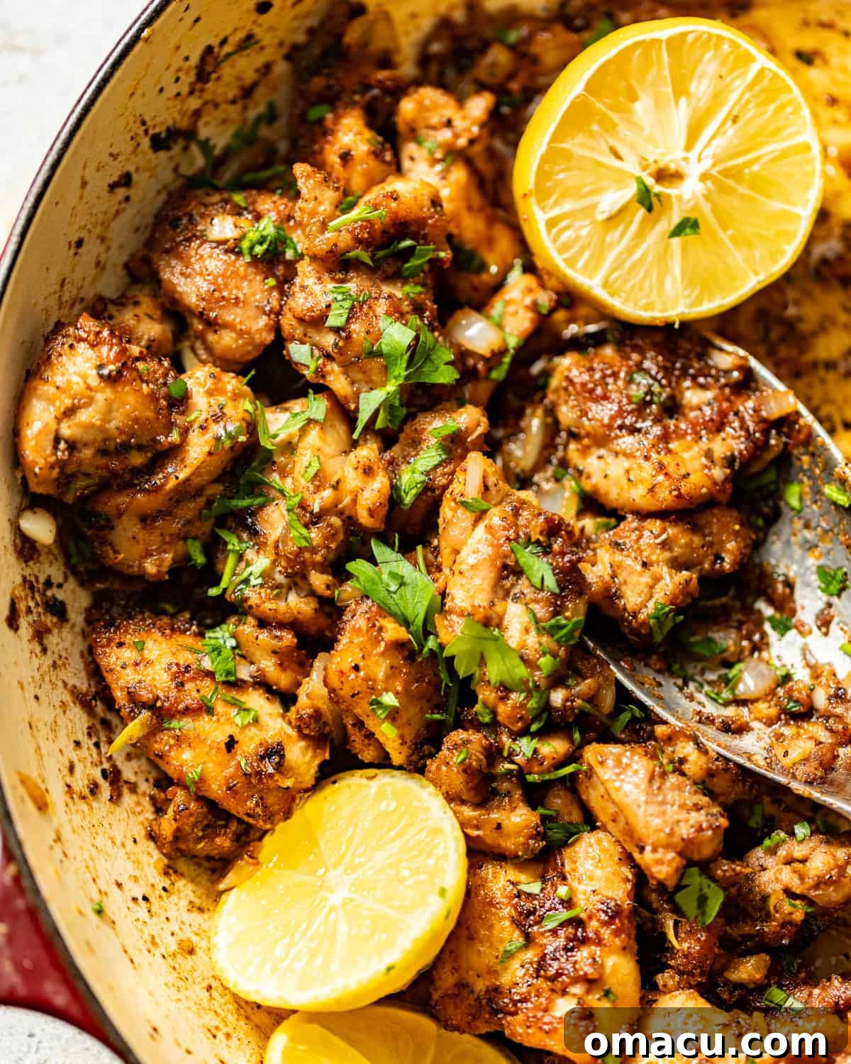 Garlic Butter Chicken Bites Recipe — Quick Savory Weeknight Meal 3 a serving spoon scooping the garlic butter chicken bites in the pan.