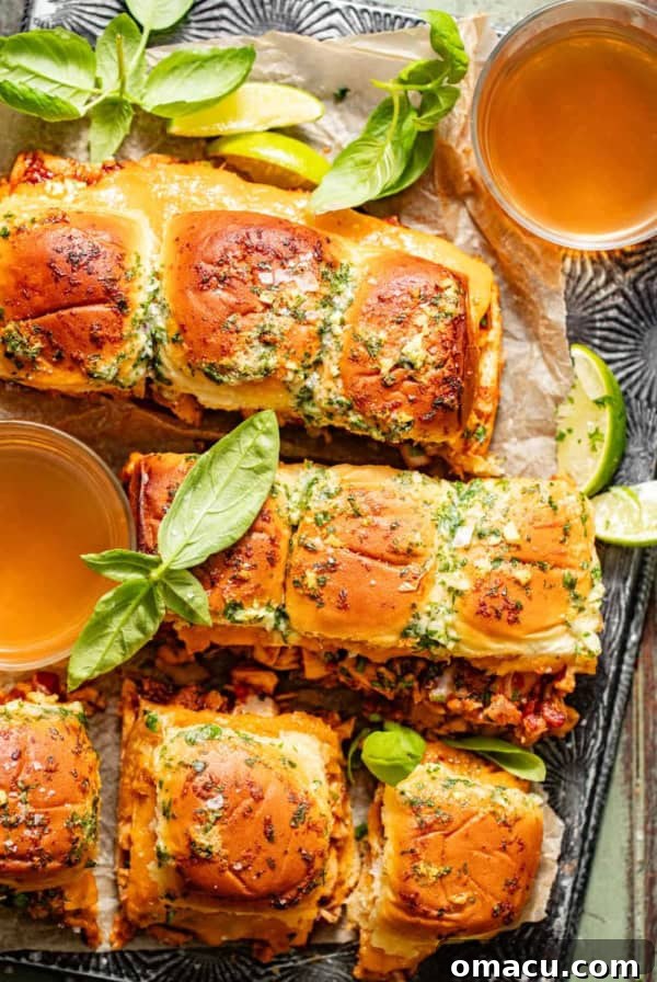 Garlic Butter Chicken Bites Recipe — Quick Savory Weeknight Meal 9 BBQ chicken sliders on a serving tray topped with garlic butter and basil.