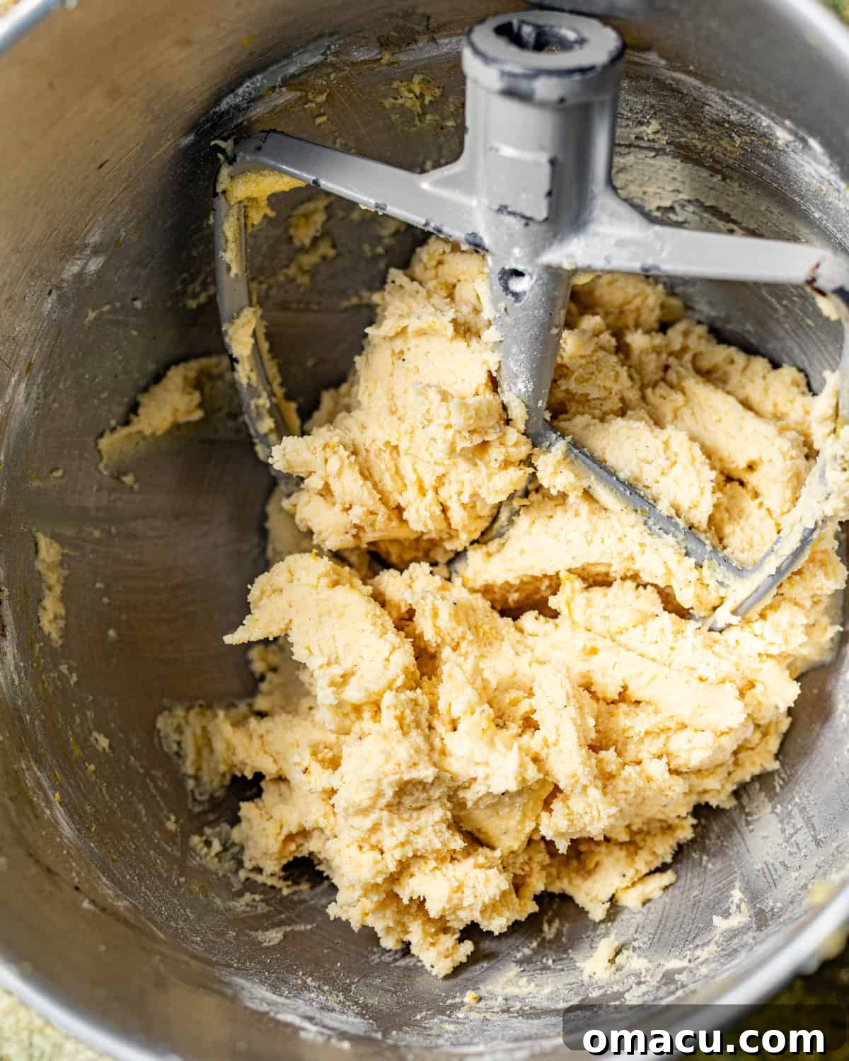 Zesty Lemon White Chocolate Chip Cookie Recipe 5 cookie dough in the bowl of a stand mixer.
