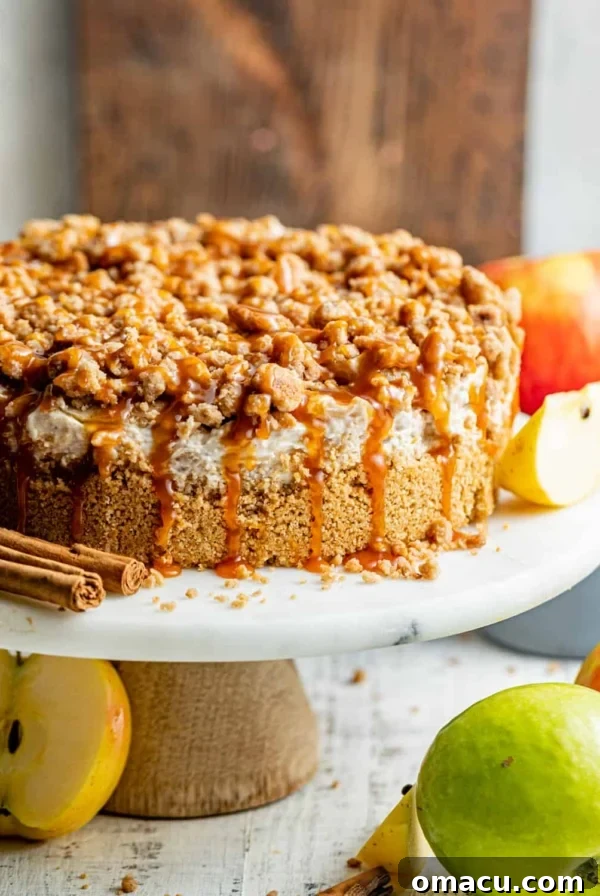 apple pie stuffed cheesecake on a cake stand.
