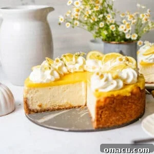 lemon cheesecake with lemon curd on a white surface with edible flowers on top.