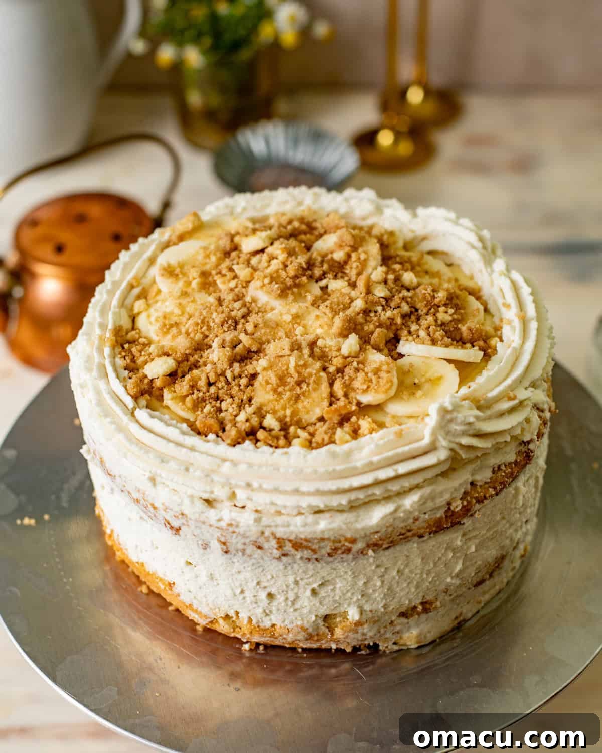 banana pudding layer cake assembled on a cake stand. 