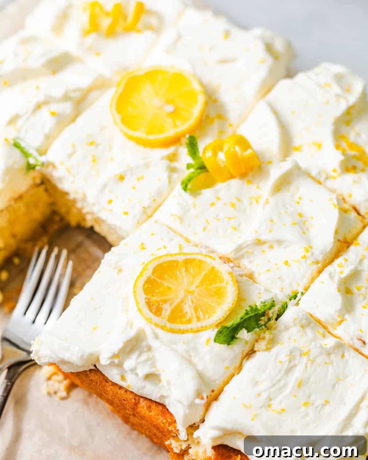 Moist Lemon Sheet Cake Recipe with Zesty Glaze 3 lemon sheet cake on a serving tray with forks.