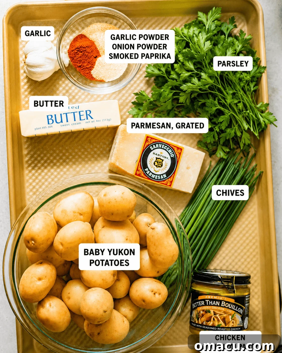 Crispy Garlic Parmesan Smashed Potatoes 3 ingredients to make garlic smashed potatoes on a baking sheet - baby potatoes, seasonings, chives, parsley, parmesan, butter, garlic, and chicken bouillon paste to boil the potatoes in.