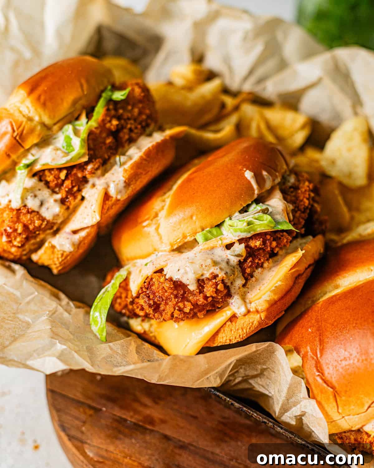 fried fish sandwiches in a serving tray stacked on top of each other.