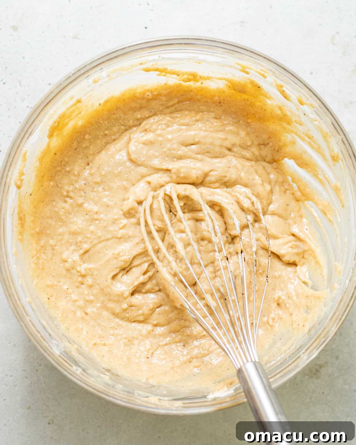 Skillet Peach Fritter Cake with Vanilla Bean Glaze 5 cake batter whisked together in a bowl.