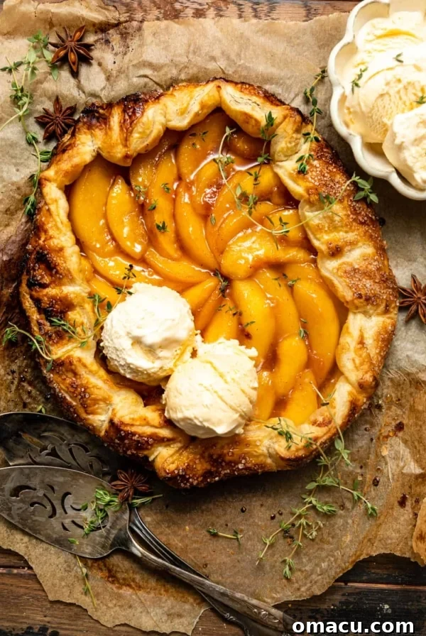 Peach Tres Leches Cobbler Recipe 12 Rustic peach galette with two scoops of vanilla ice cream on top.