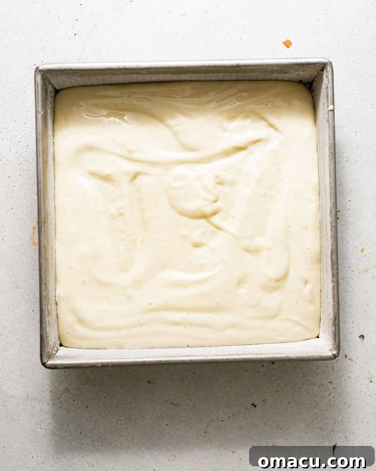 Peach Tres Leches Cobbler Recipe 6 tres leches cake batter in a square baking pan.