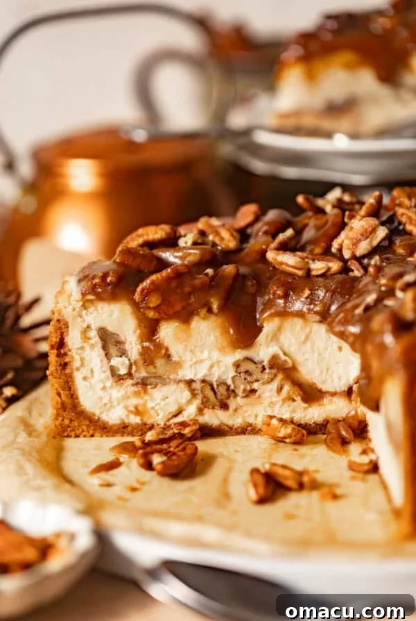 Salted Caramel Peach Cobbler Cheesecake Recipe 13 sliced pecan pie cheesecake on a serving plate topped with pecan pie filling.