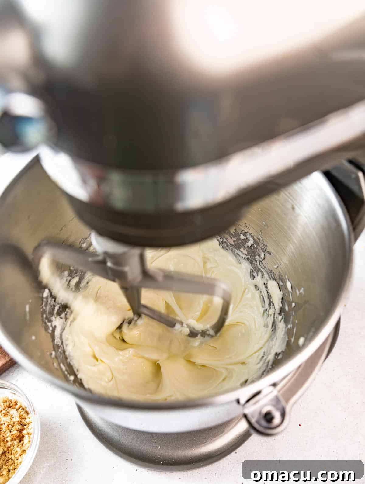 Salted Caramel Peach Cobbler Cheesecake Recipe 7 cheesecake batter in the bowl of a stand mixer fitted with the paddle attachment.