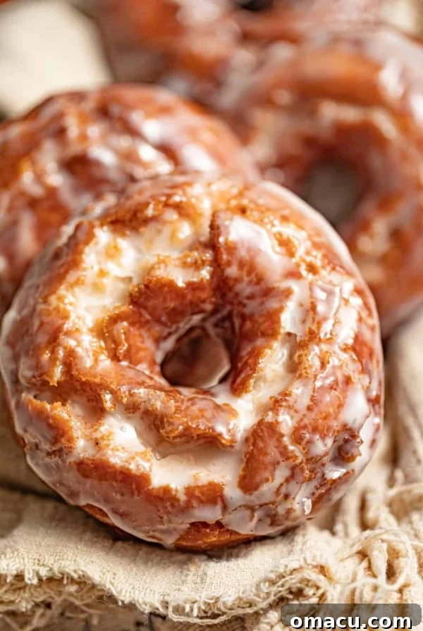 Classic Maple Cake Donuts Recipe 12 old fashioned sour cream donuts on a beige cloth.