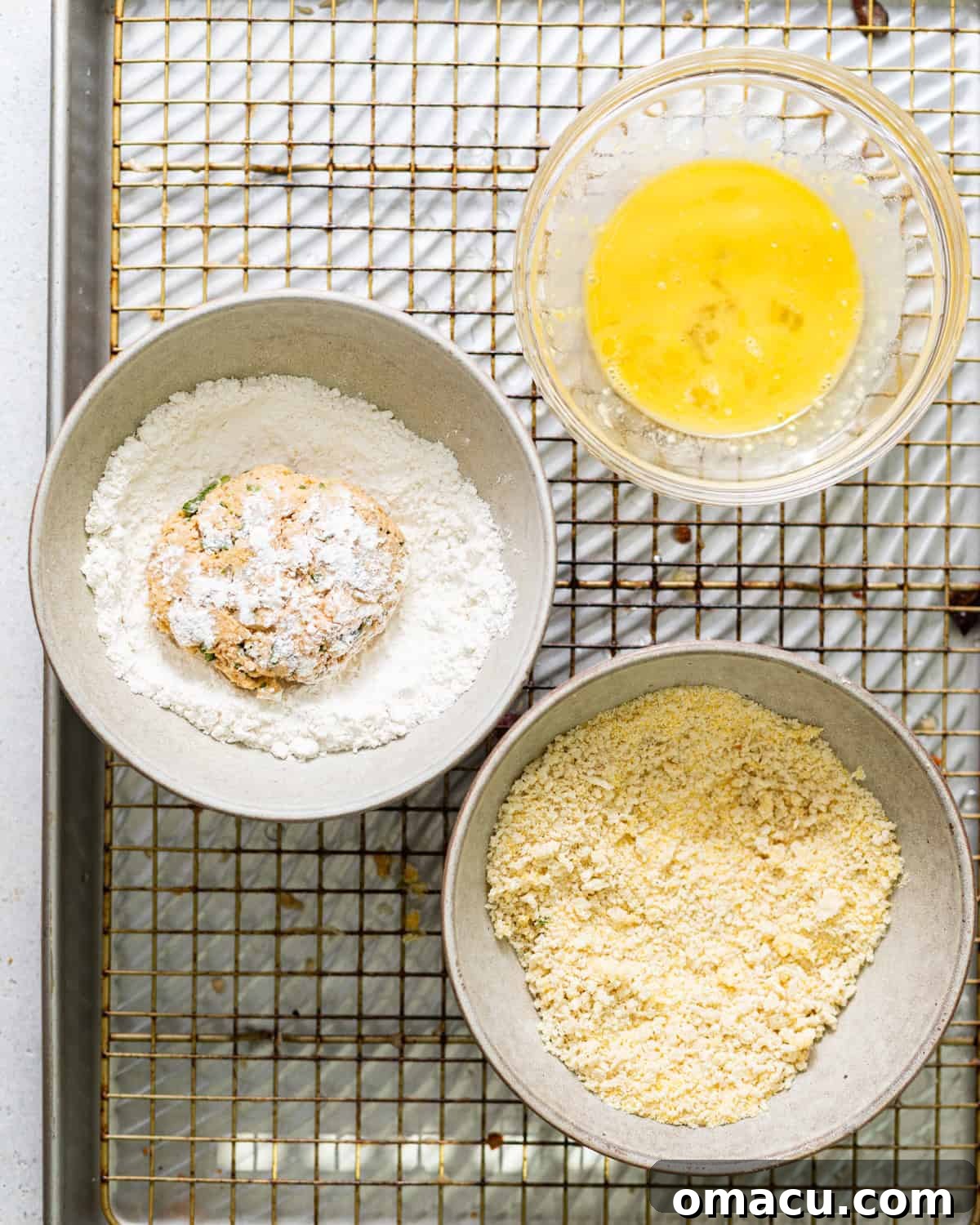 Bowls with flour, egg, and cornmeal coating