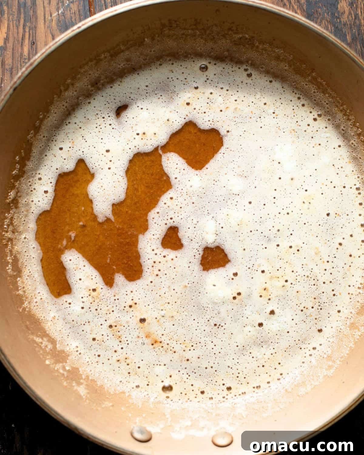 Classic Italian Cream Cake Recipe with Cream Cheese Frosting 4 Brown butter and toasted milk solids foaming in a saucepan.