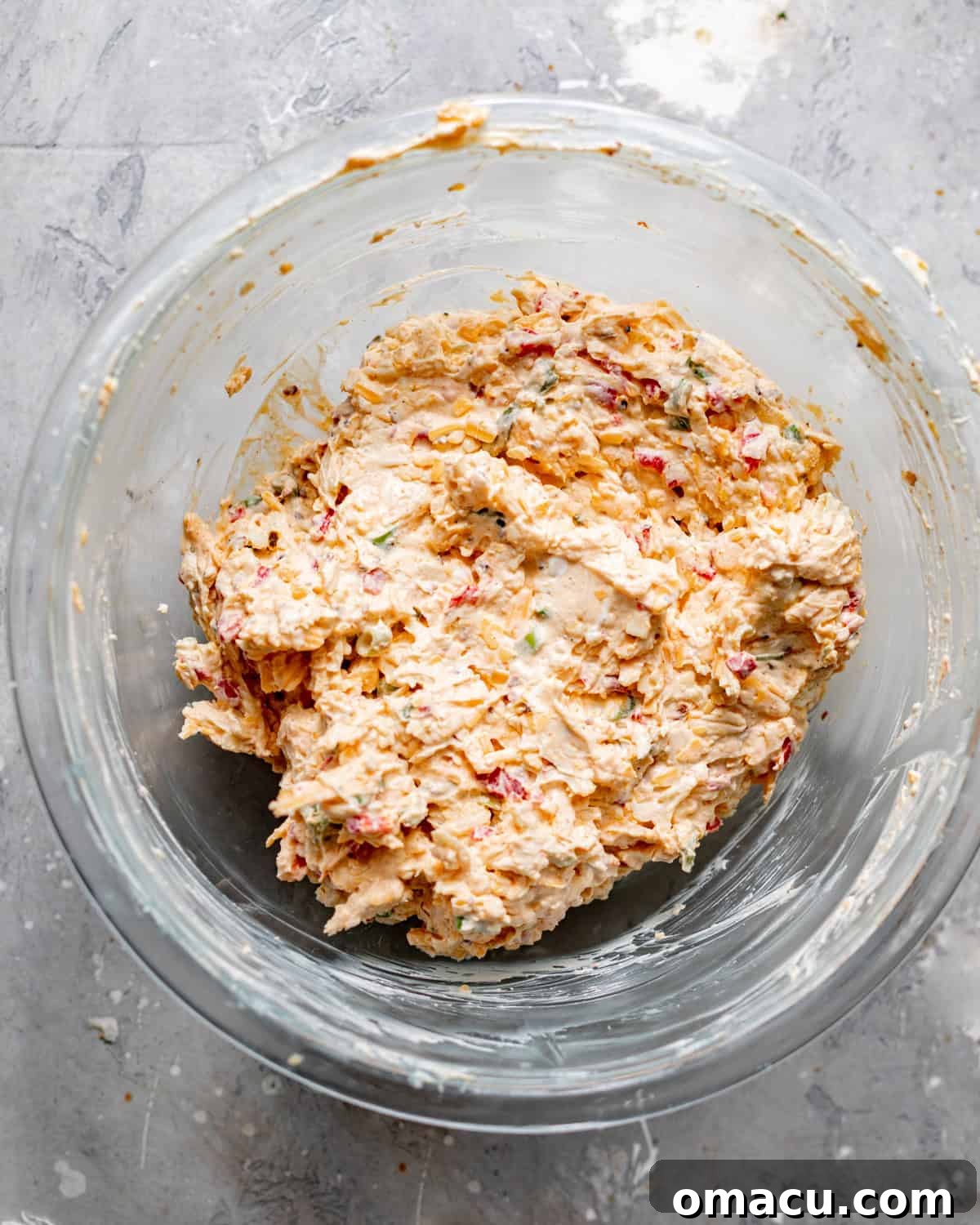 Creamy Southern Pimento Cheese Dip for Game Day 4 pimento cheese ingredients mixed together in a mixing bowl before chilling in the refrigerator.