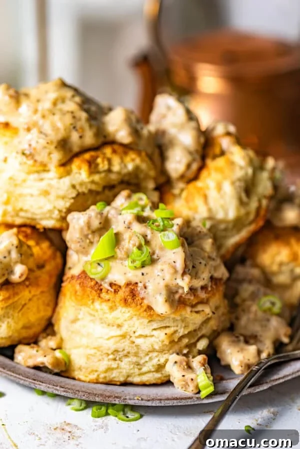 Crispy Southern Fried Green Tomatoes Recipe 11 southern biscuits and gravy on a plate garnished with chopped green onions.