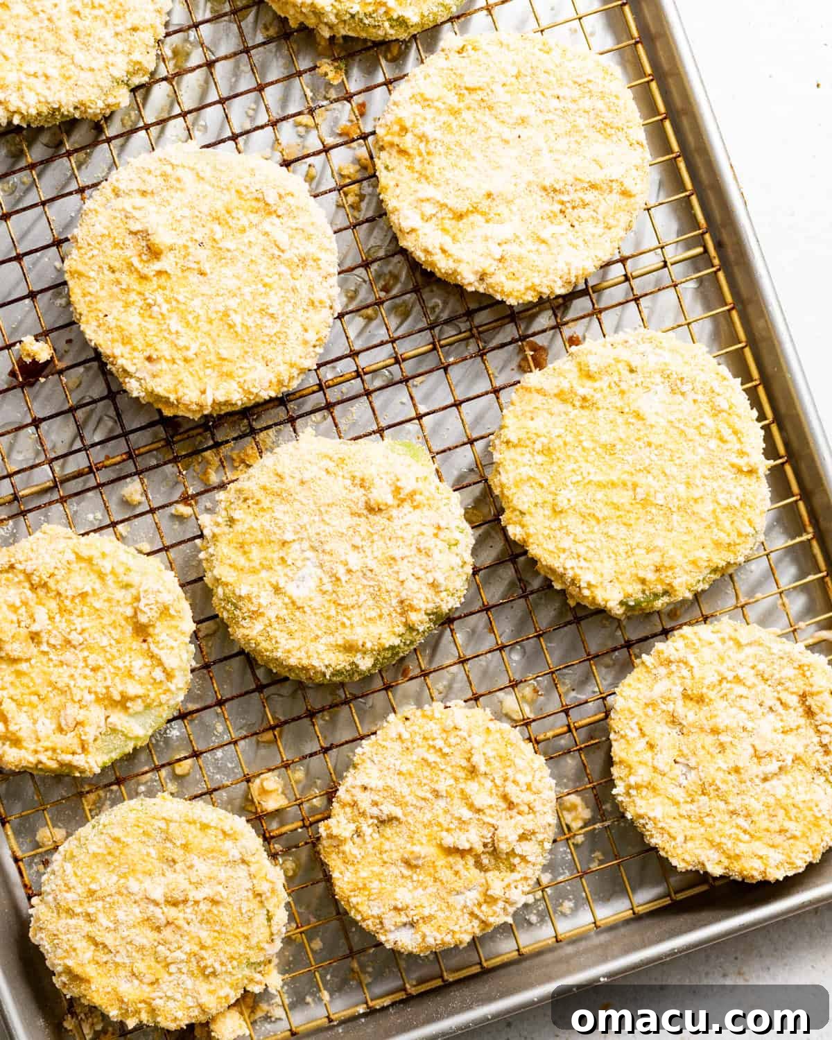 Crispy Southern Fried Green Tomatoes Recipe 6 bread green tomato slices on a wire rack before frying.